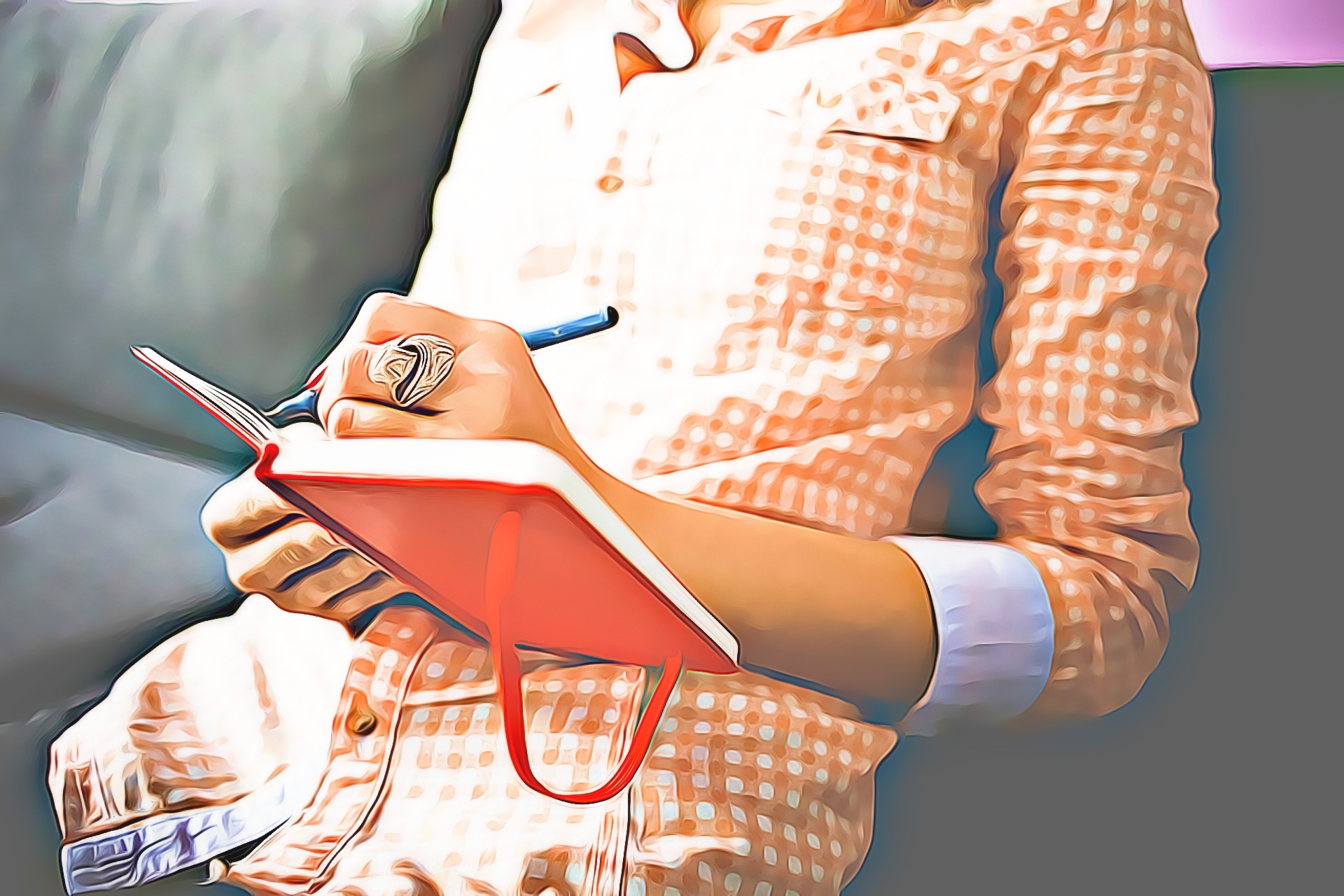 sitting female with orange top writing in red journal